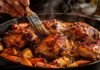 Glazed chicken thighs with roasted root vegetables in a cast iron skillet